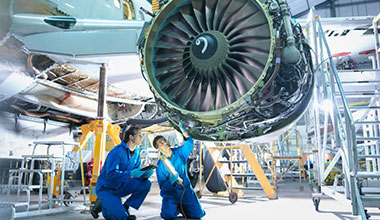Engineers Working on Jet Engine